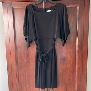 Very flattering black knit dress with cape sleeves.